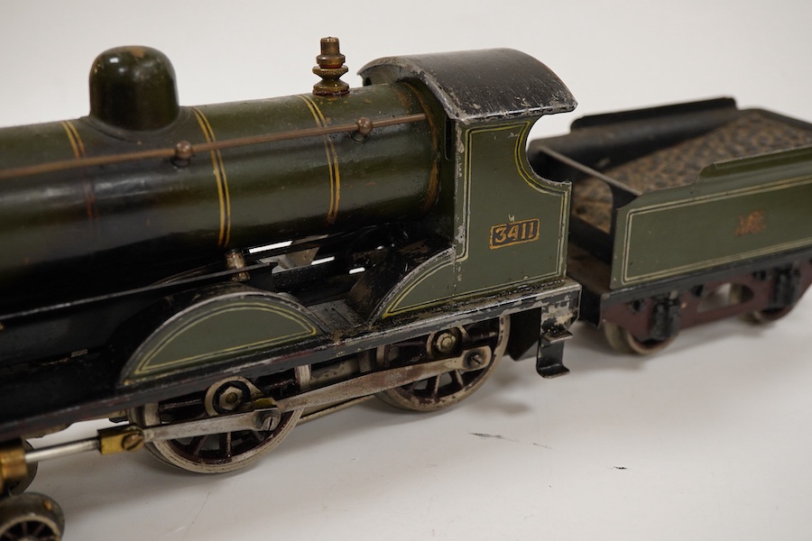 An 0 gauge live steam spirit fired tinplate GWR 4-4-0 tender locomotive, possibly Bing for Bassett-Lowke, 3411, with original fuel tank and burner, two controls in the cab and four wheel tender